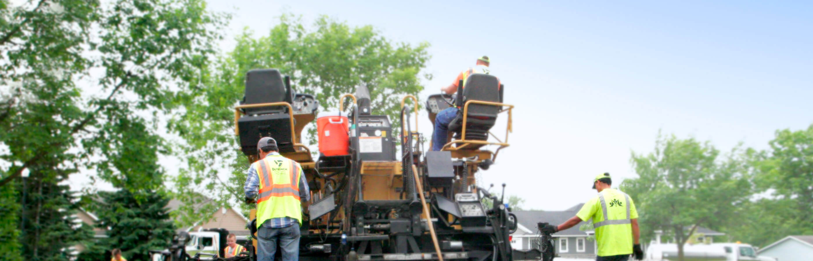 View of Duinick workers on the back of a paver