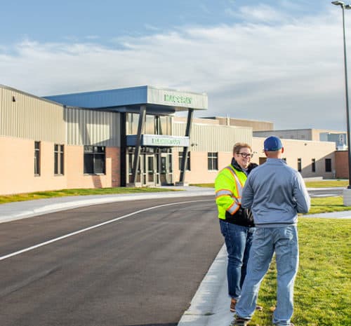 Duininck estimator or school superintendent talking in front of a newly renovated school