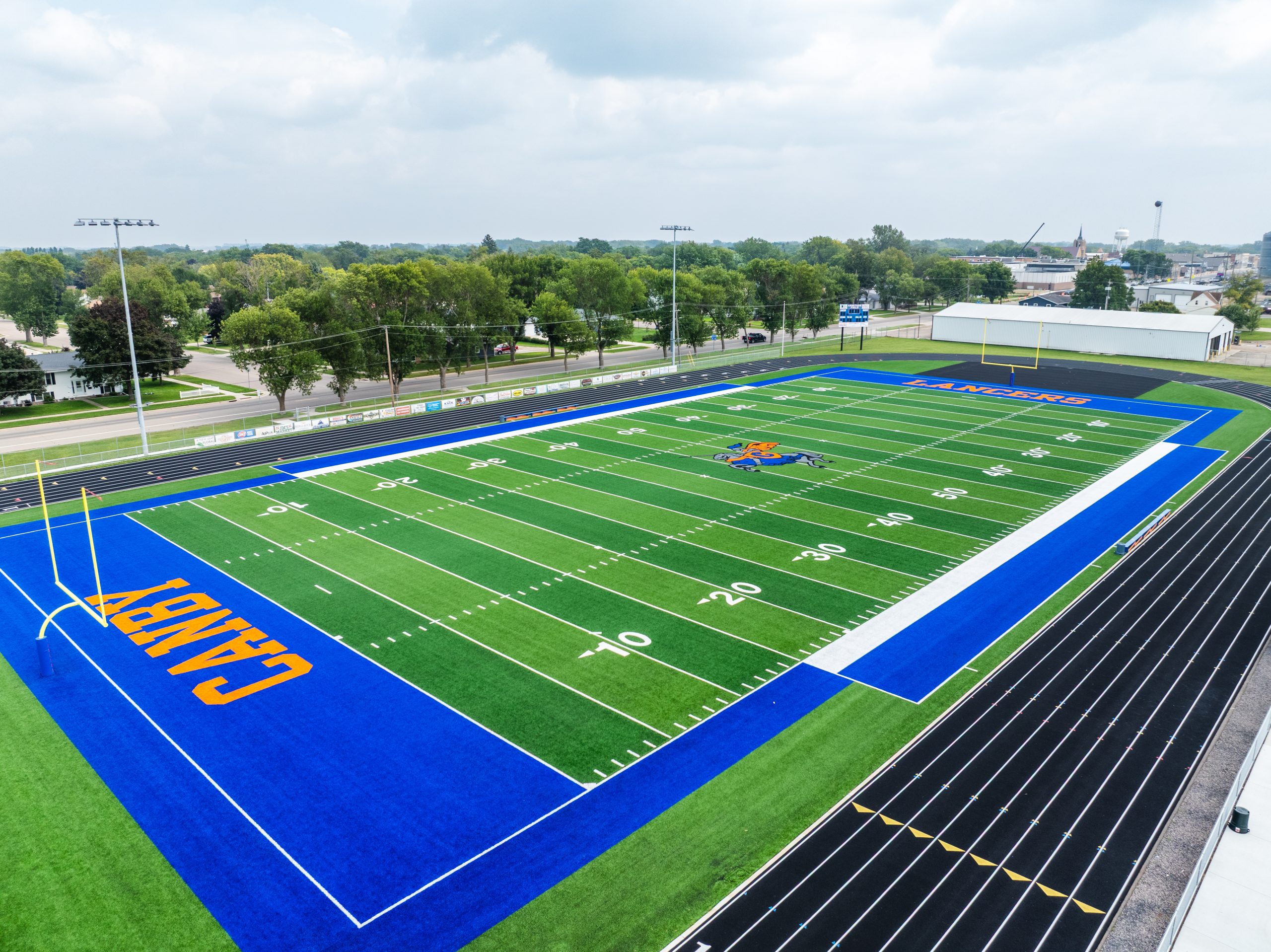 Aerial view of a vibrant, modern football field and running track.