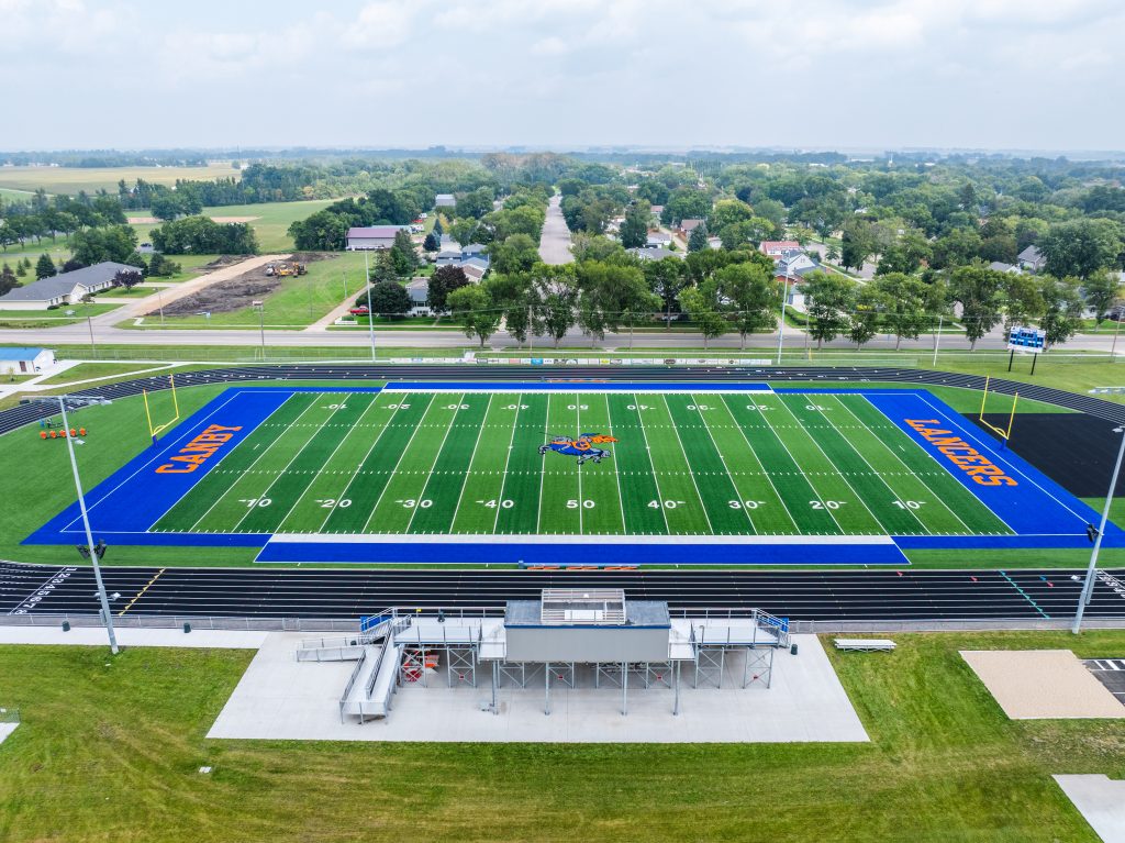 Aerial view of a modern high school football field with track.
