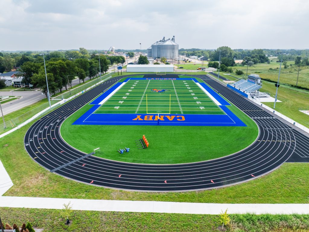 Aerial view of a vibrant football field and running track