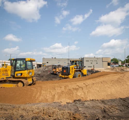 2021 yellow bulldozers on a construction site with dirt